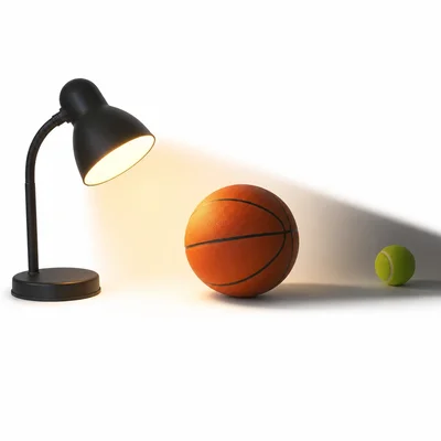 A lamp, basketball, and tennis ball arranged to model a lunar eclipse, with the tennis ball in the basketball's shadow.