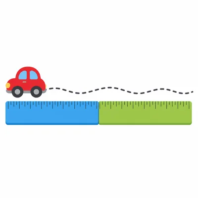 A toy car path extends beyond two rulers.