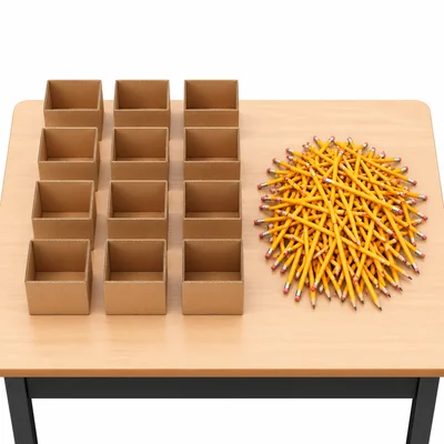 Twelve open boxes next to a pile of pencils for an equal sharing problem.