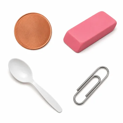 A copper coin, rubber eraser, plastic spoon, and metal paper clip.