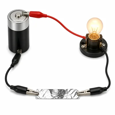 A battery and bulb circuit testing a strip of aluminum foil.