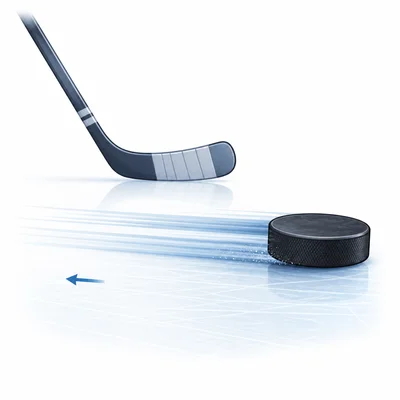 A hockey puck glides on smooth ice after the stick stops touching it.